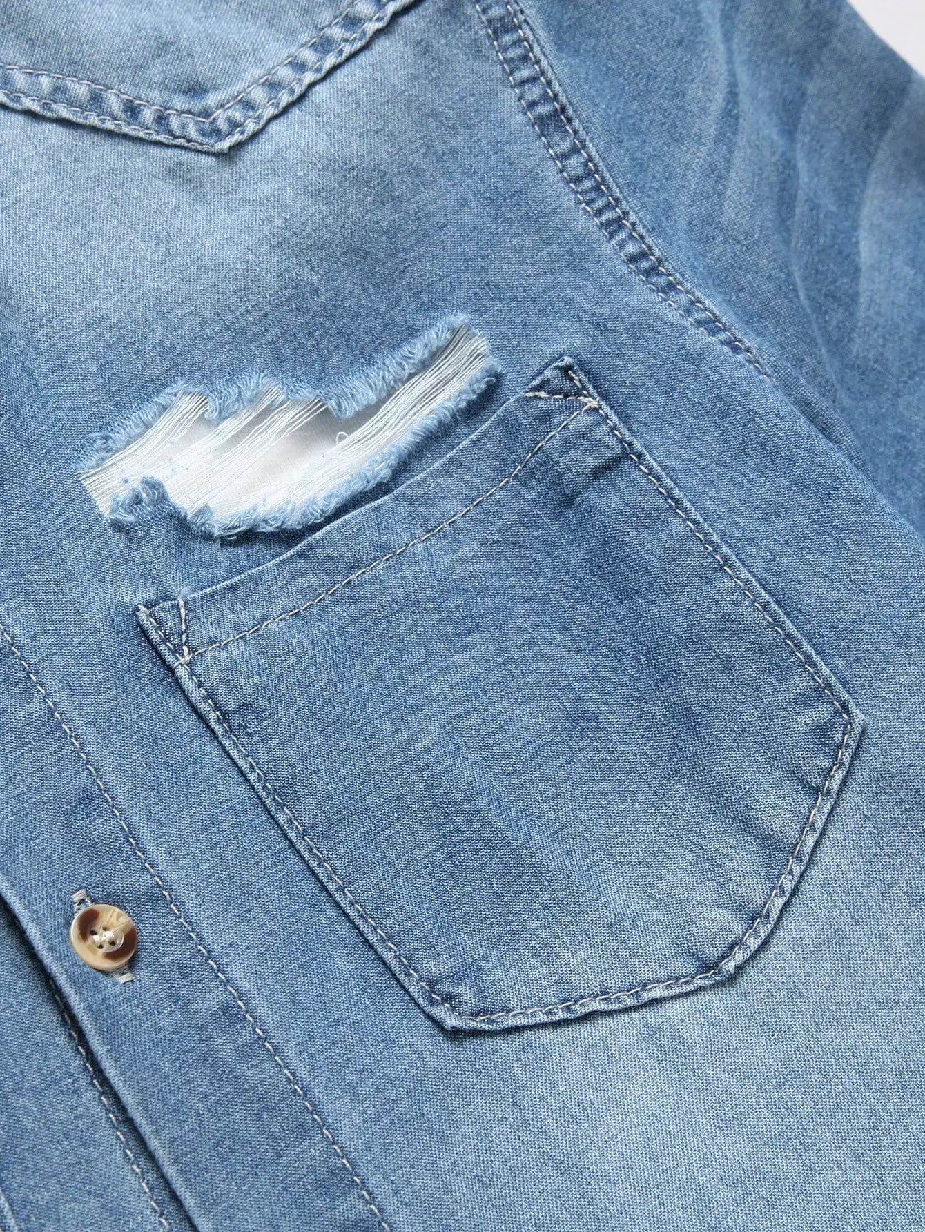 Chemise d'été en jean bleu à manches courtes pour homme, avec détails déchirés. Les détails déchirés soulignent un style tendance et décontracté.